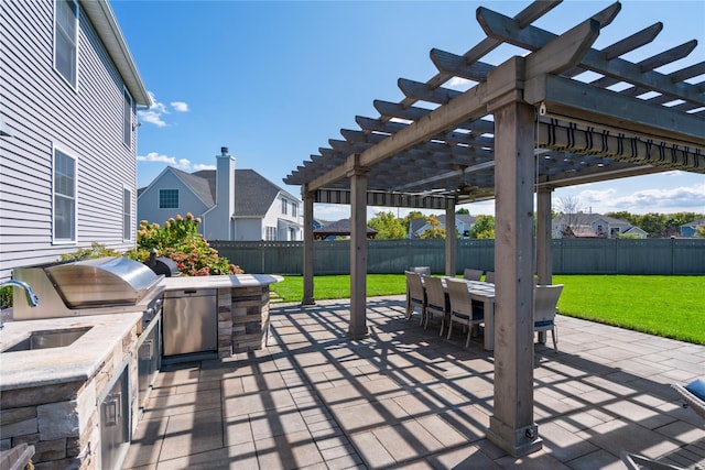 view of patio featuring an outdoor kitchen, a pergola, and sink