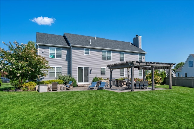 back of house with a yard, a pergola, and a patio