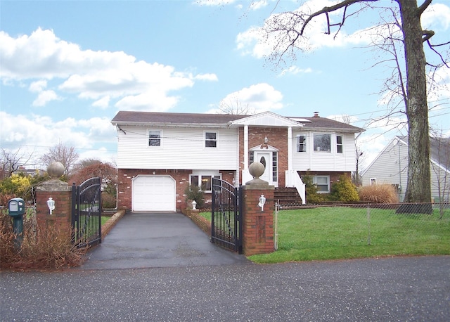 bi-level home featuring a garage and a front lawn