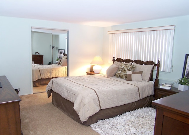 bedroom with light colored carpet and a closet