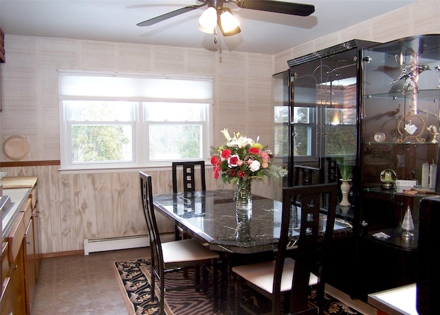 dining area with baseboard heating and ceiling fan