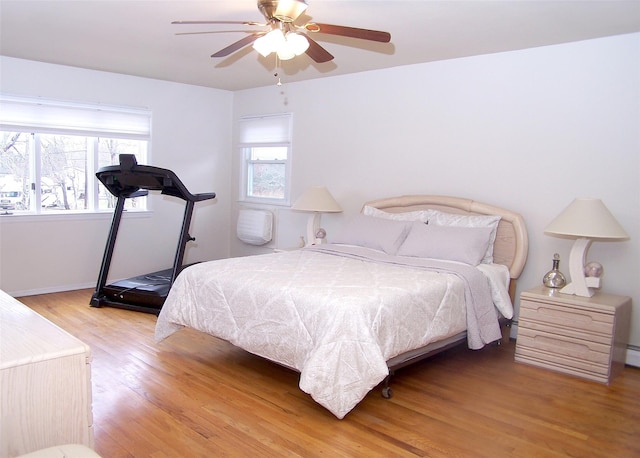 bedroom with ceiling fan and light wood-type flooring