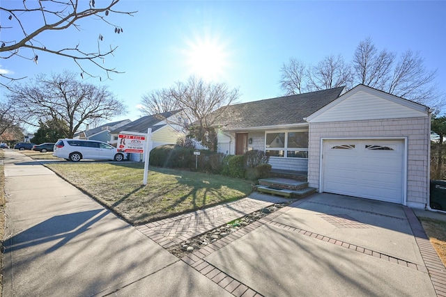 ranch-style home with a front yard and a garage