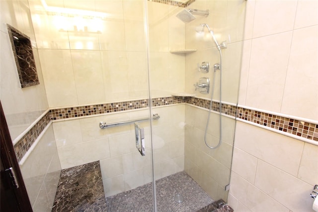 bathroom with a shower with shower door