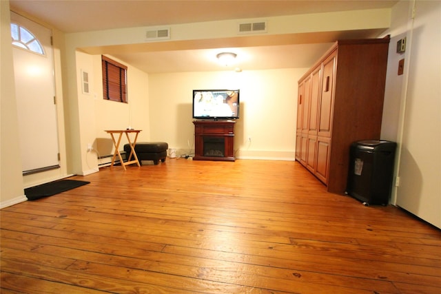 living room featuring light hardwood / wood-style floors and baseboard heating