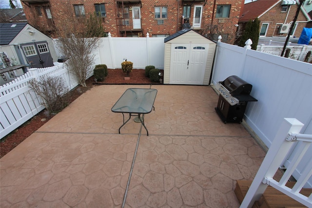 view of patio featuring a shed and grilling area