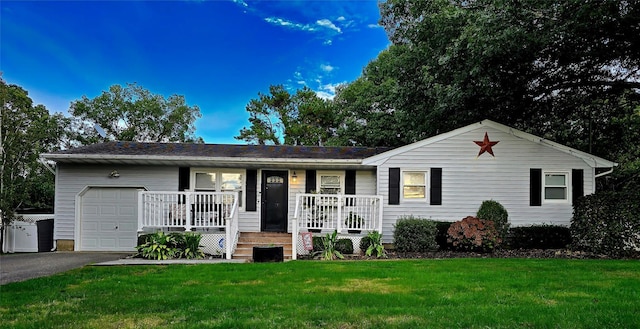 ranch-style home with a porch, a garage, and a front lawn