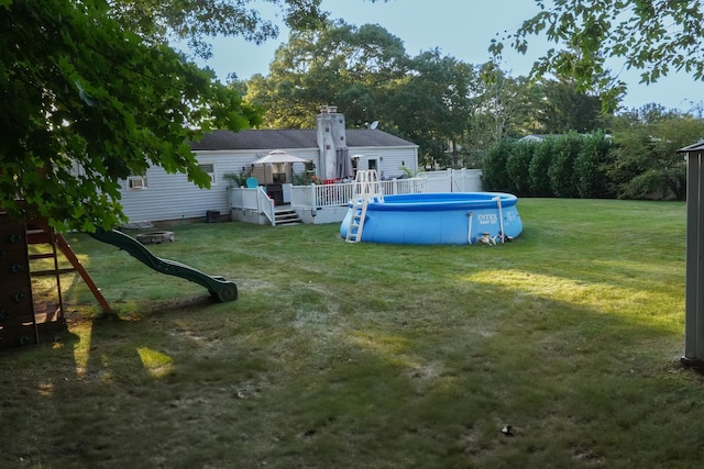 view of yard with a pool side deck