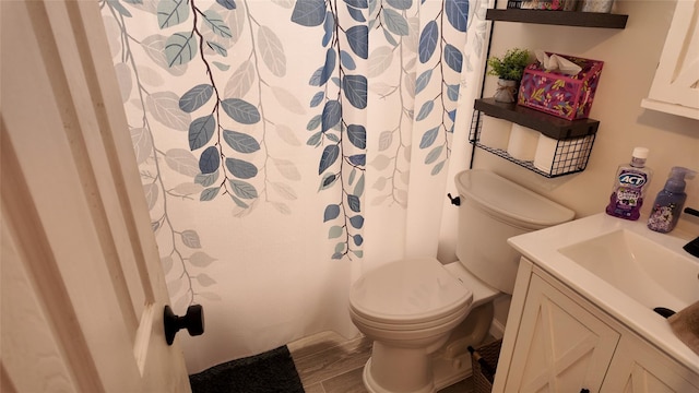 bathroom with vanity, hardwood / wood-style floors, a shower with shower curtain, and toilet