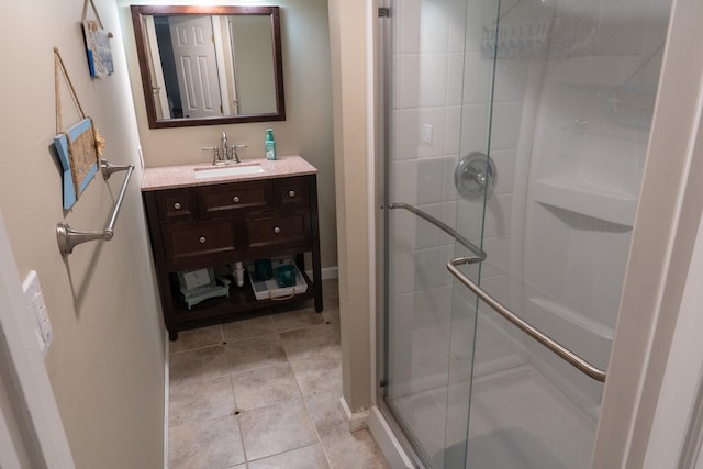 bathroom with tile patterned flooring, vanity, and a shower with shower door