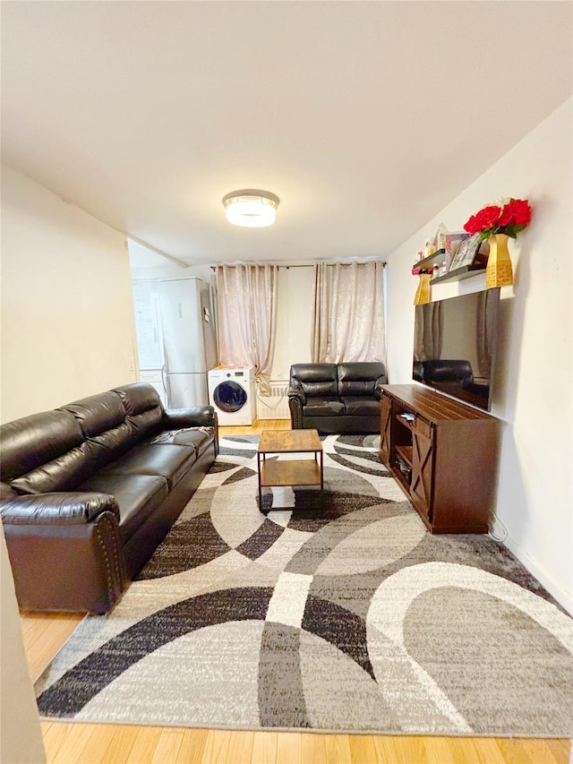 living room featuring heating unit and hardwood / wood-style flooring