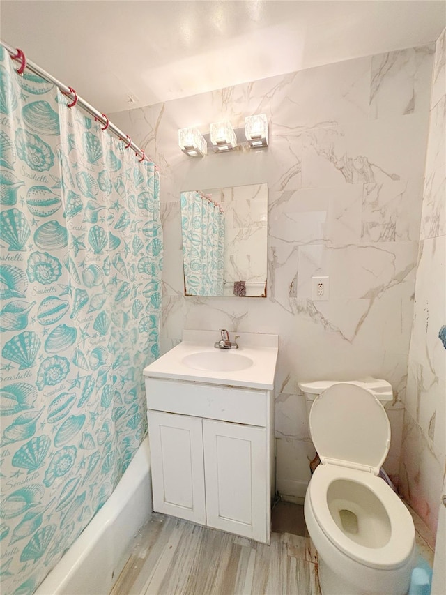 full bathroom with toilet, shower / tub combo with curtain, vanity, tile walls, and hardwood / wood-style flooring