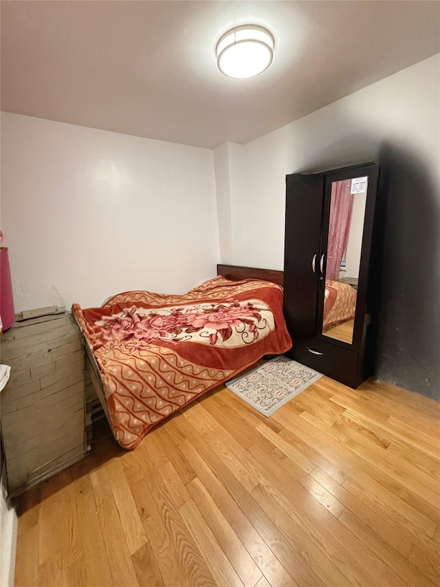 bedroom with wood-type flooring