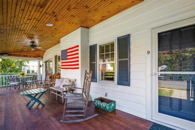 wooden deck featuring a porch and a ceiling fan