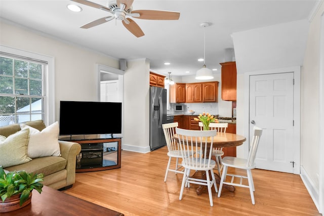 dining area featuring baseboards, ceiling fan, crown molding, light wood-style floors, and recessed lighting