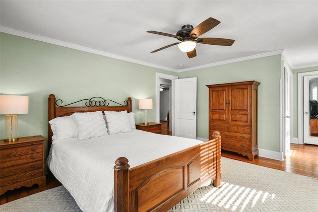 bedroom featuring ornamental molding, light wood-type flooring, ceiling fan, and baseboards