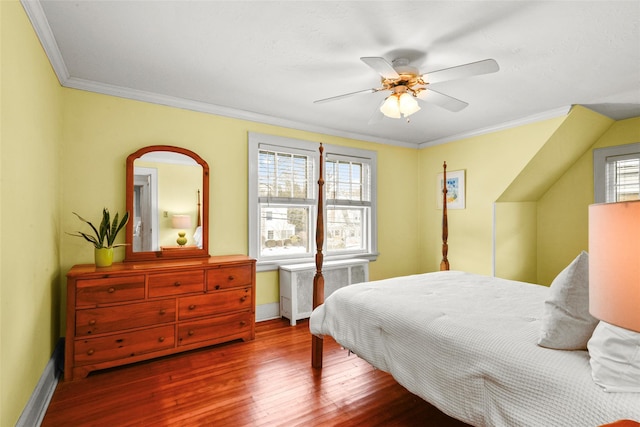 bedroom featuring crown molding, baseboards, radiator heating unit, and wood finished floors