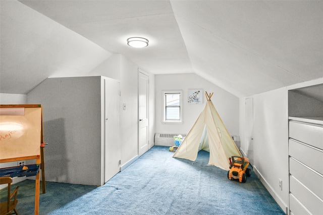 playroom with lofted ceiling and dark colored carpet