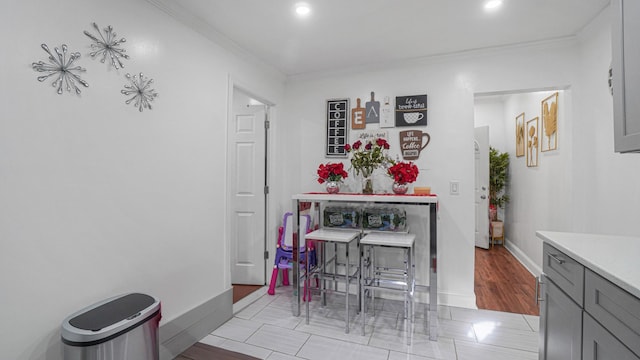 dining area featuring light tile patterned floors and ornamental molding