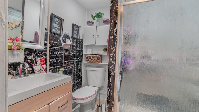 bathroom with vanity, toilet, and an enclosed shower