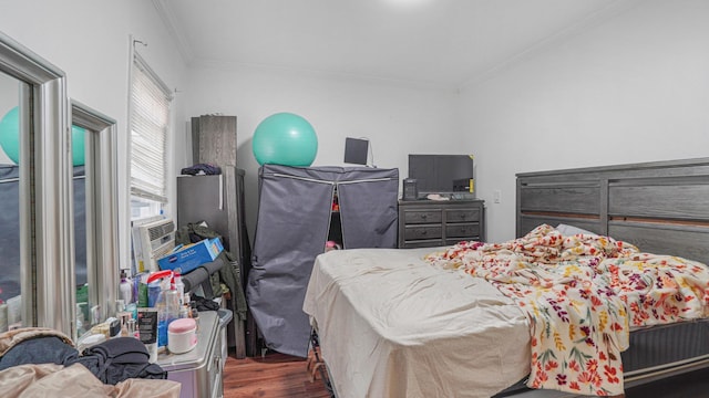 bedroom with dark hardwood / wood-style floors and ornamental molding