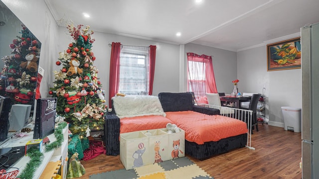 bedroom featuring ornamental molding and hardwood / wood-style flooring