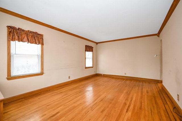 empty room with light wood-type flooring and ornamental molding