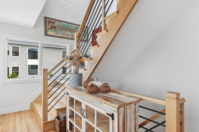 staircase with hardwood / wood-style flooring