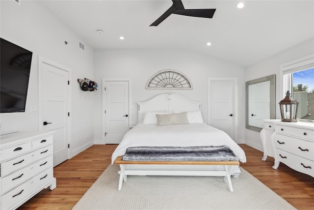 bedroom featuring light hardwood / wood-style floors, vaulted ceiling, and ceiling fan