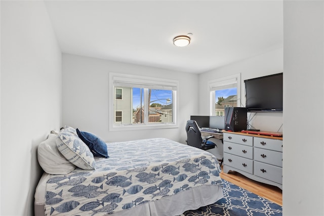 bedroom with hardwood / wood-style flooring