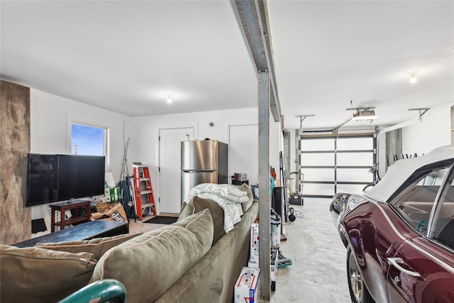 garage featuring stainless steel fridge and a garage door opener