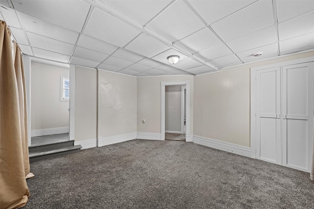 basement with carpet flooring and a paneled ceiling