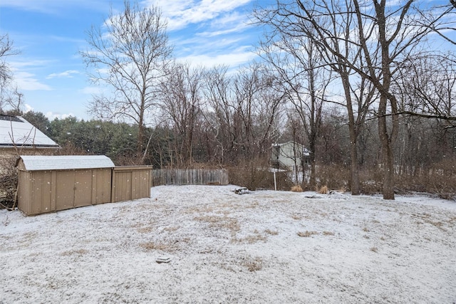 yard covered in snow with an outdoor structure