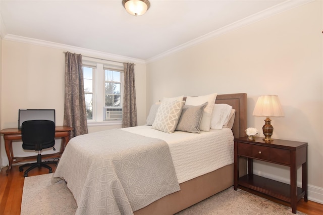 bedroom featuring hardwood / wood-style flooring, cooling unit, and ornamental molding