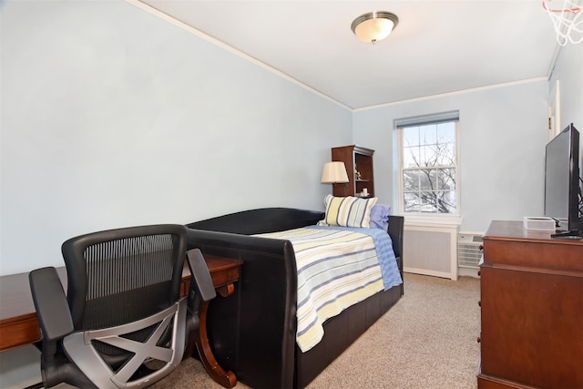 bedroom with ornamental molding and light carpet