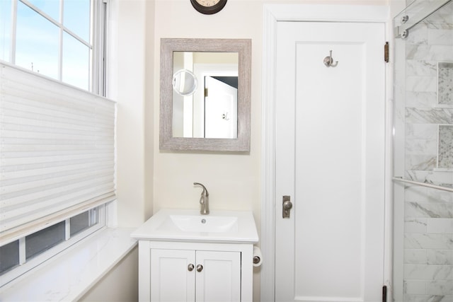 bathroom featuring vanity and tiled shower