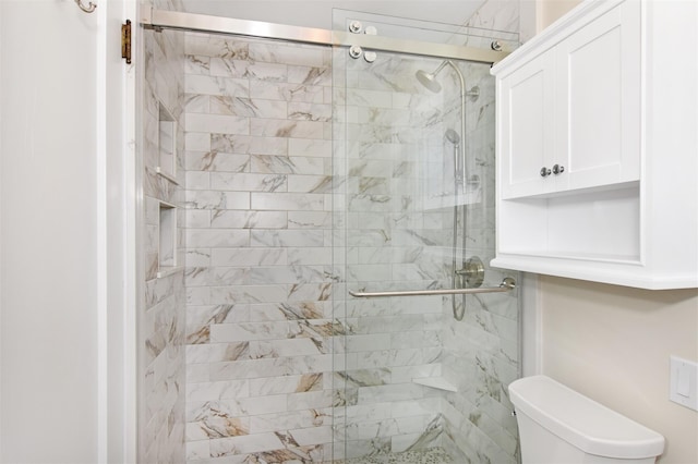 bathroom featuring an enclosed shower and toilet