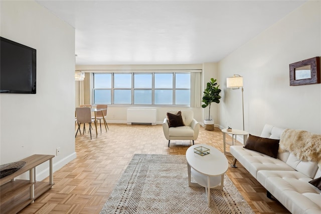 living area featuring baseboards