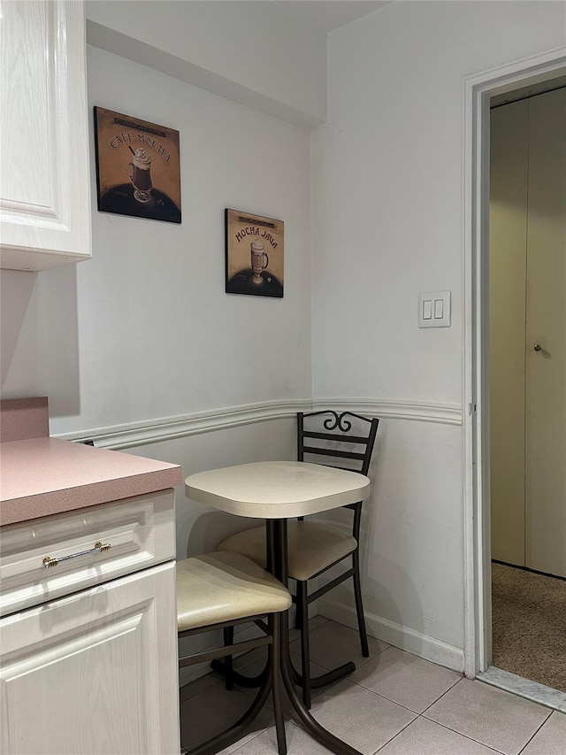 dining area with light tile patterned floors