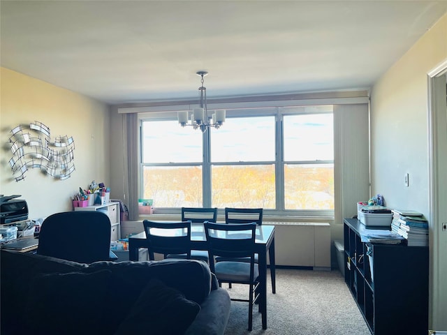 dining room featuring carpet flooring, a chandelier, and a healthy amount of sunlight