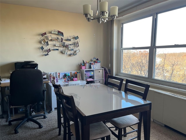 dining area with carpet flooring and a chandelier