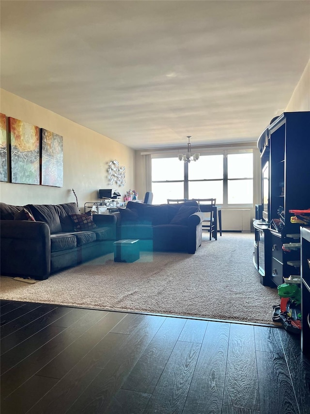 living room with a notable chandelier and hardwood / wood-style flooring