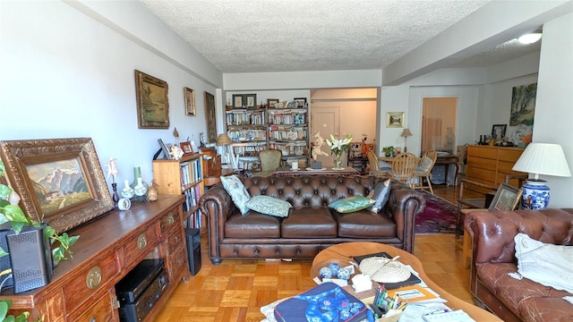 living room featuring light parquet flooring and a textured ceiling