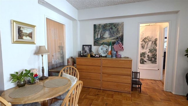 living area with parquet floors and a textured ceiling