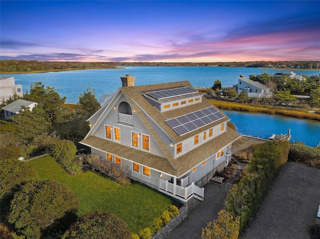 aerial view at dusk with a water view