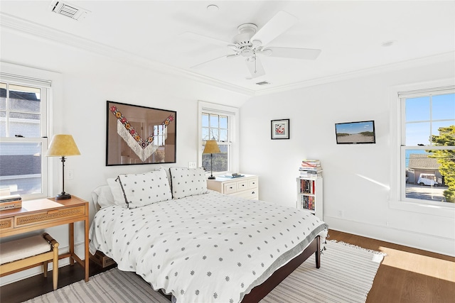 bedroom with ceiling fan, dark hardwood / wood-style floors, and ornamental molding