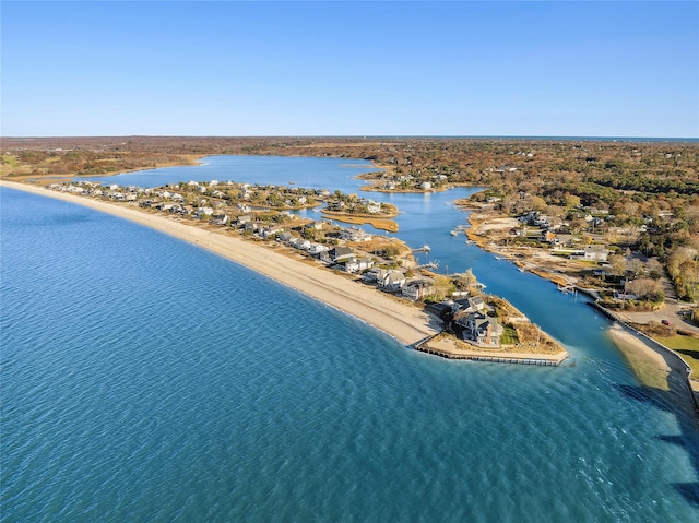 birds eye view of property featuring a beach view and a water view