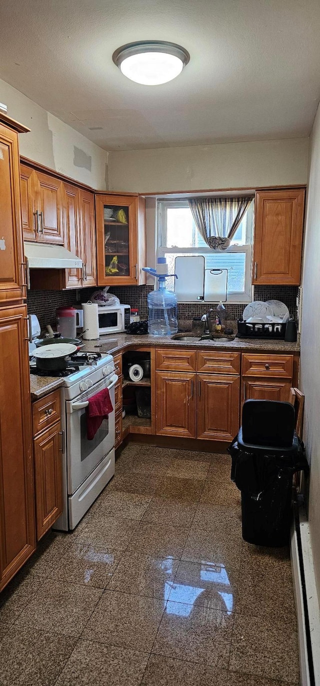 kitchen featuring white appliances and backsplash