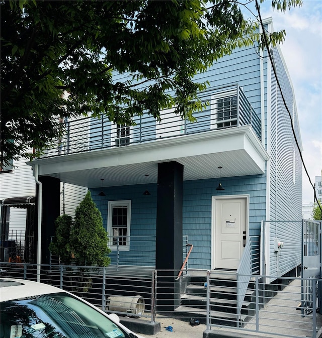 view of front of house with a balcony