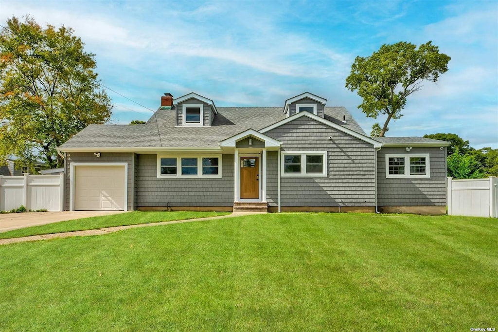 view of front of home with a garage and a front lawn